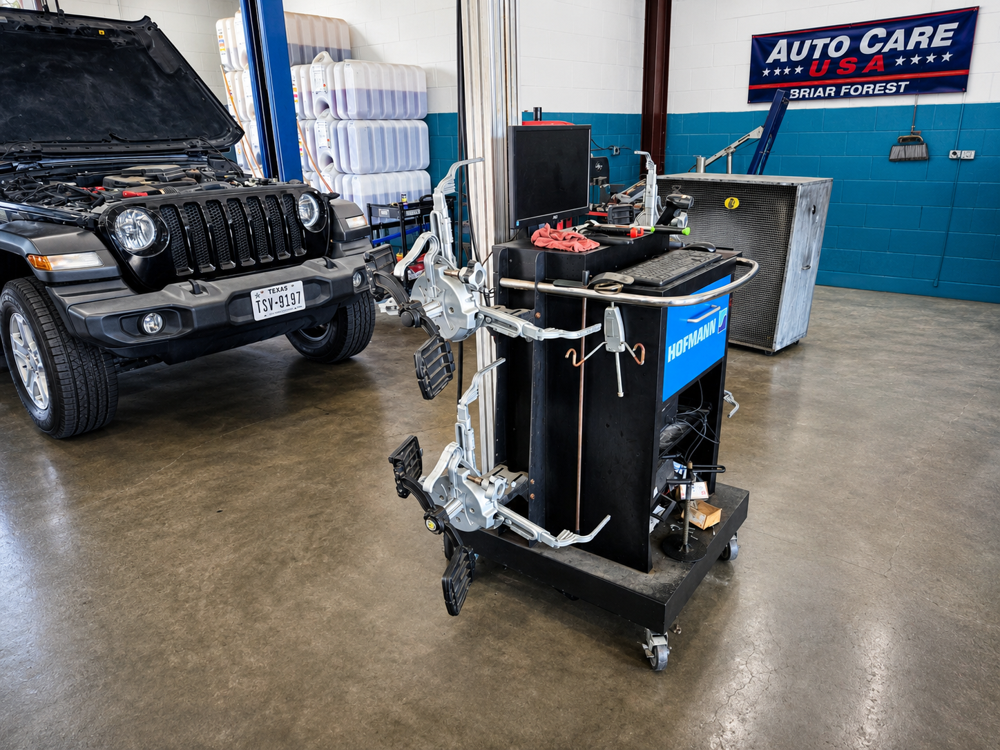 Hofmann wheel alignment machine in a service bay at Auto Care USA Briar Forest