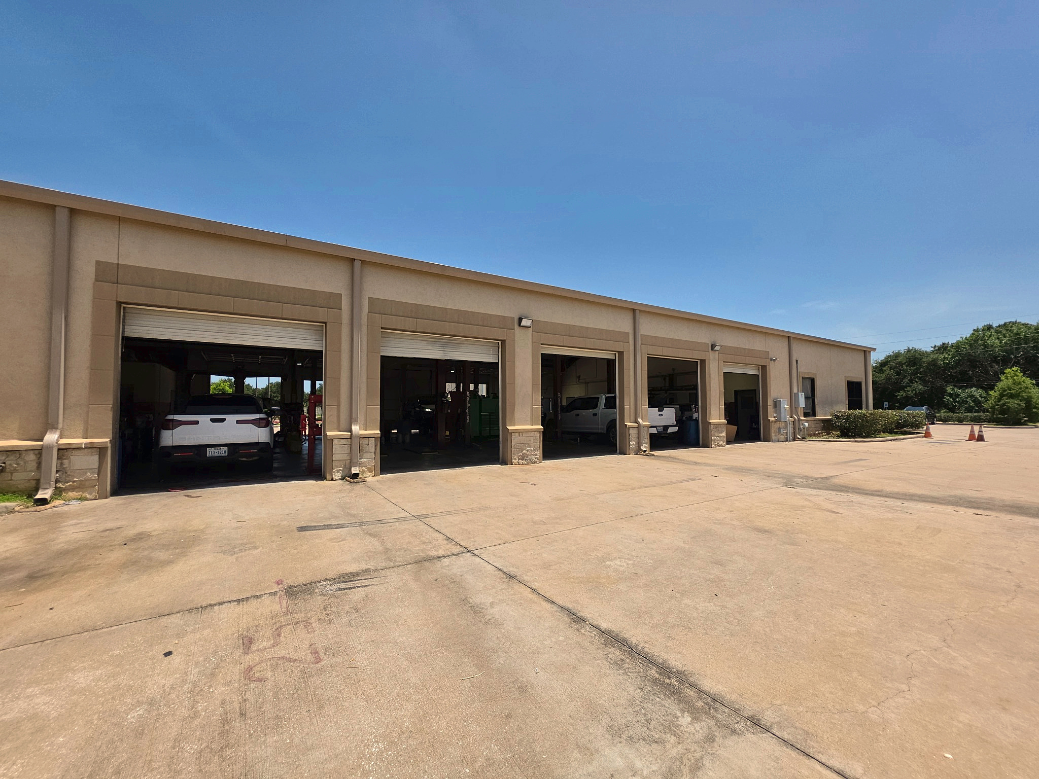 Auto repair shop interior with service bays at Auto Care USA in Rosenberg, TX