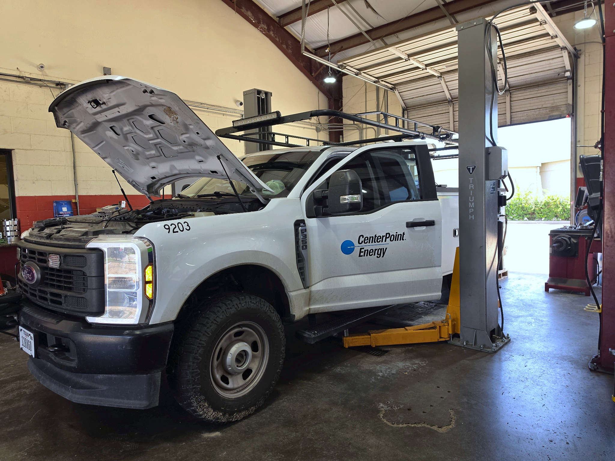 Commercial fleet truck on a lift at Auto Care USA in Rosenberg, TX