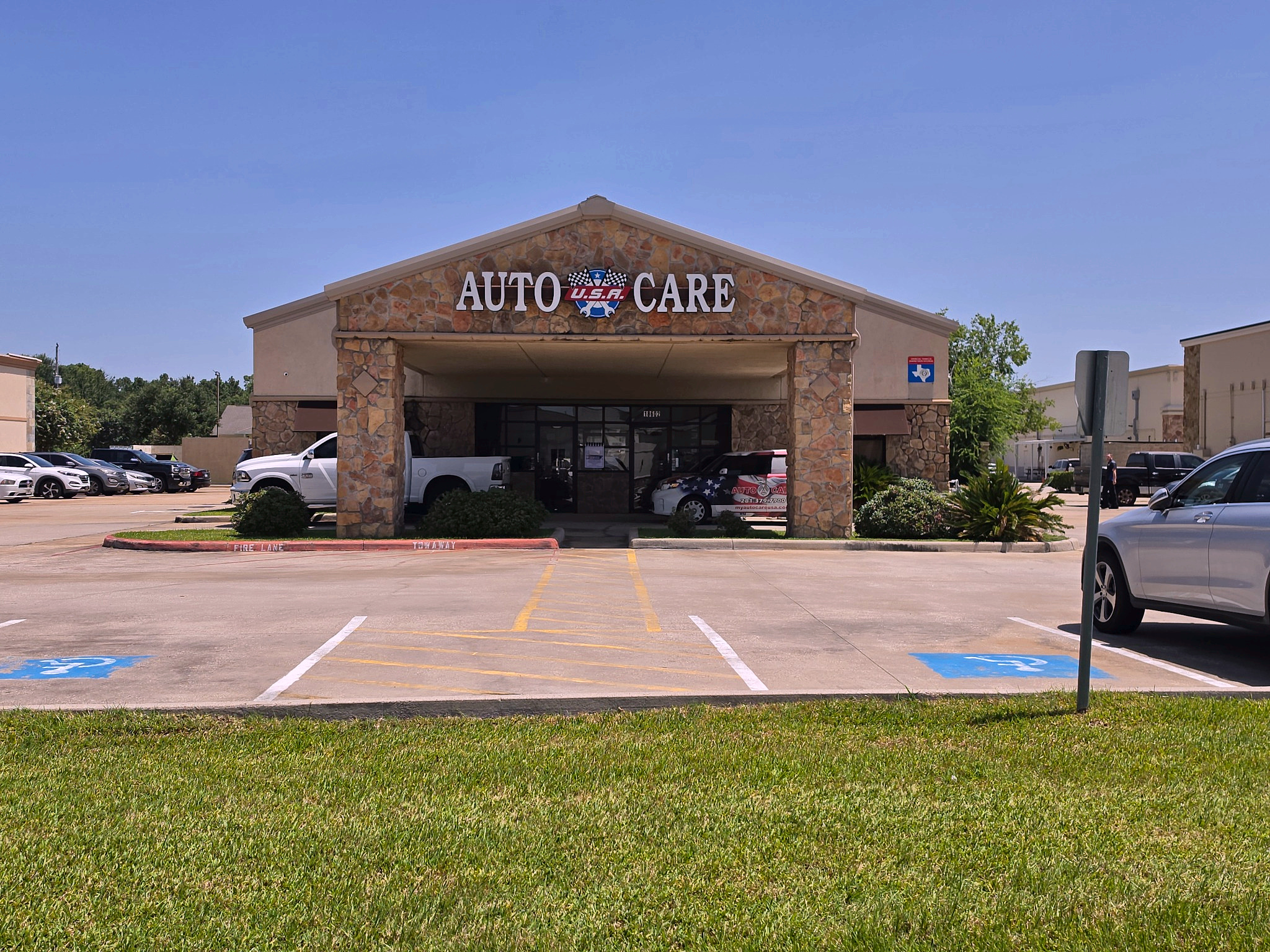 Front entrance and covered drive-up at Auto Care USA in Spring, TX