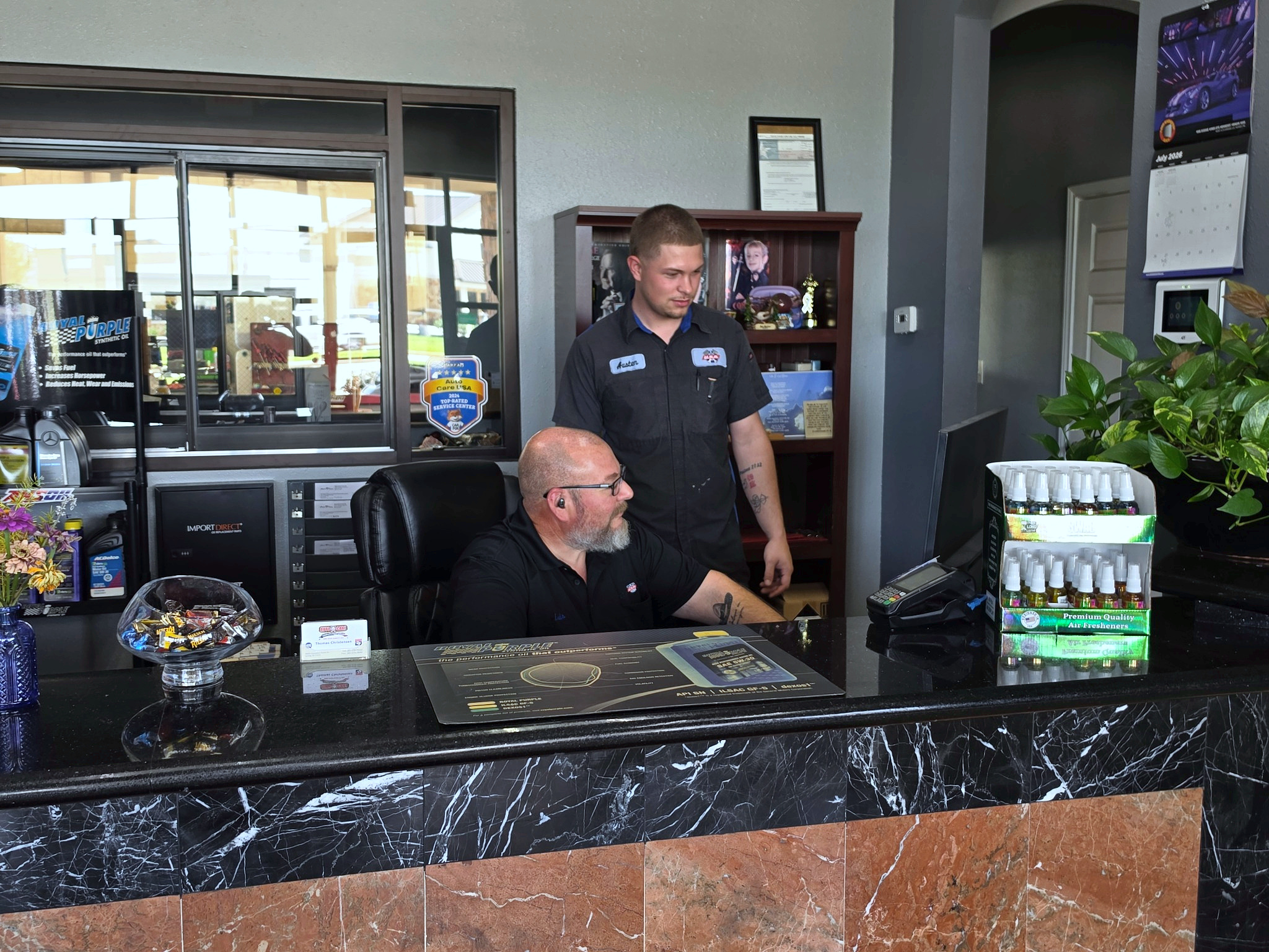 Friendly customer service team at the front desk of Auto Care USA in Spring, TX