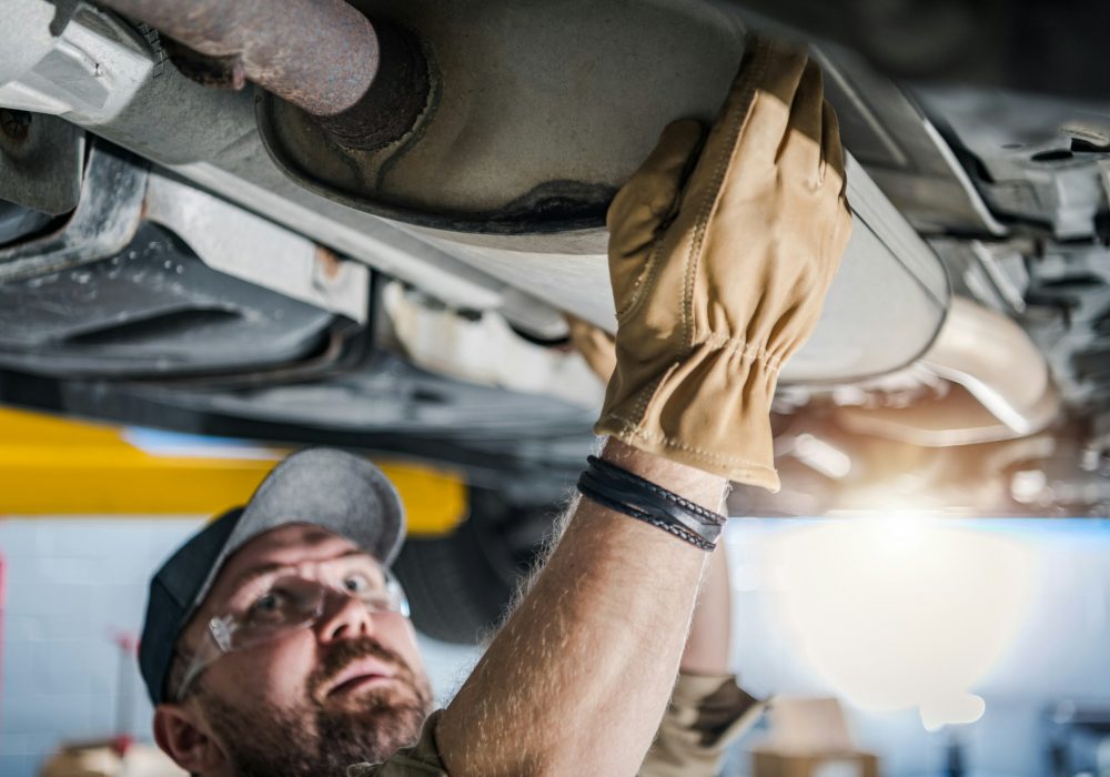 Professional Mechanic Performing Car Catalytic Converter Check